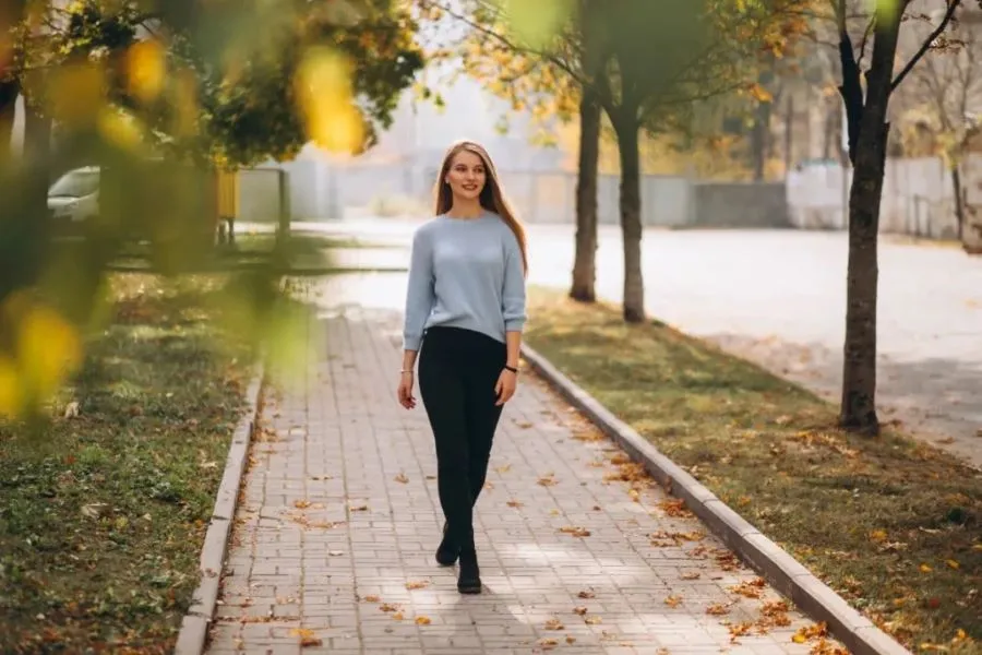 A young girl is walking in the park