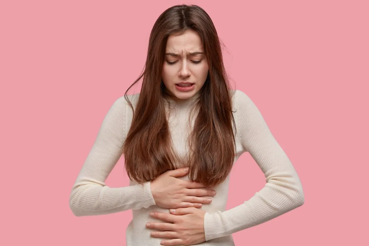 A girl with Symptoms often include gas and bloating after eating