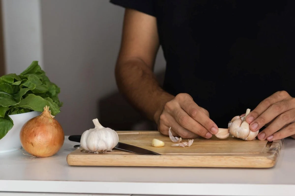 A man chopping garlic