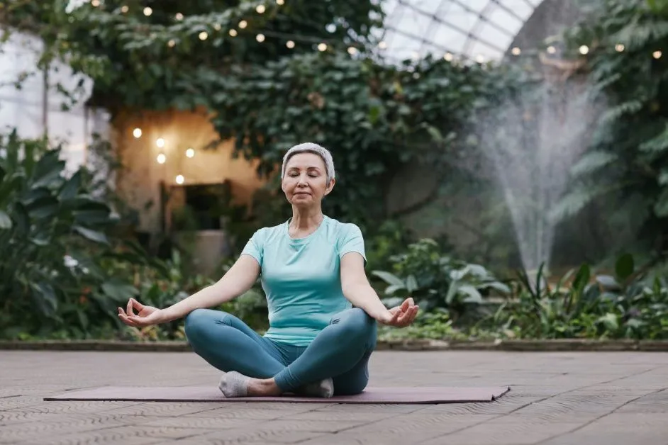 An old woman meditation on yoga mate