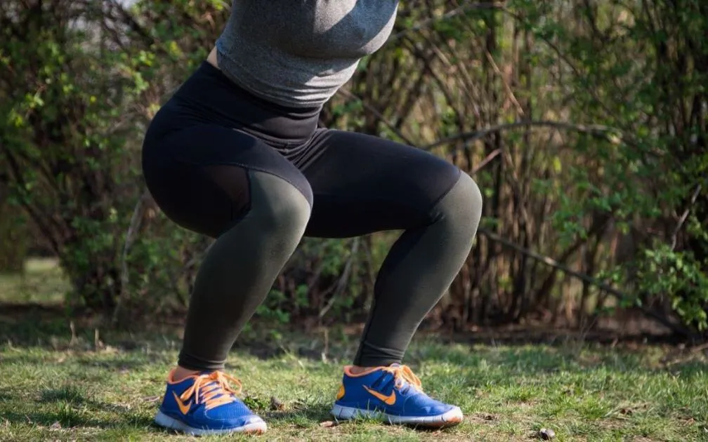 A fit woman exercising in the park