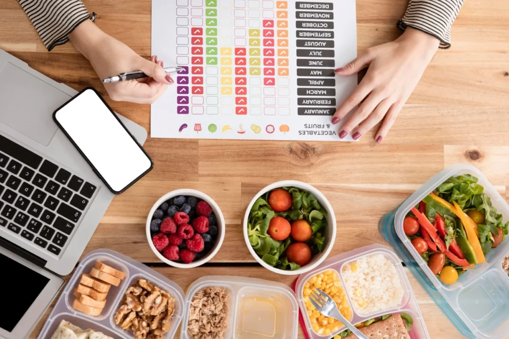 Flat lay charts and organic food in lunch boxes